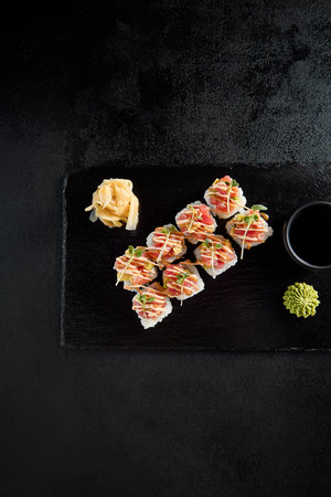 Sushi roll with tuna tartare and avocado on a black slate.の写真素材