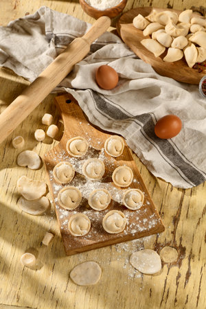 Pelmeni on a wooden board, a rustic scene showcasing Slavic culinary traditions.の写真素材