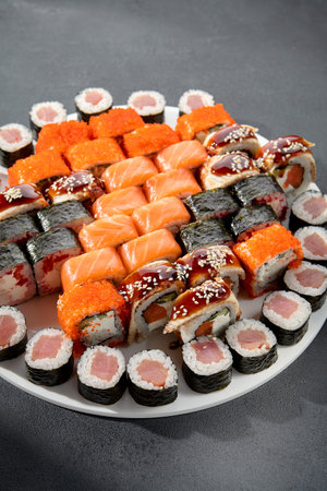 Assorted sushi and maki rolls platter with tuna, salmon, and eel, perfect for a Japanese cuisine experience.の写真素材