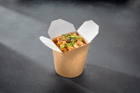 Rice glass noodles with chicken fillet in a wok box, a convenient option for an Asian-inspired quick bite.の写真素材