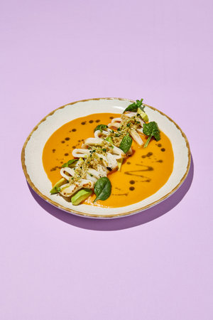 Squid with Avocado, Quinoa, and Tomato Tom Yum, Healthy Food Concept. Suitable for Culinary Arts and Modern Cuisine.の写真素材
