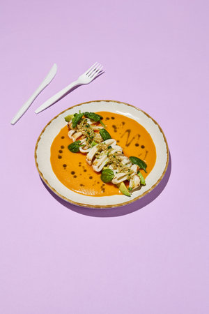 Squid, Avocado, Quinoa, and Tomato Tom Yum with White Plastic Utensils. Contemporary Healthy Food Concept.の写真素材