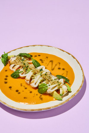 Squid with Avocado, Quinoa, and Tomato Tom Yum, Healthy Food Concept. Suitable for Culinary Arts and Modern Cuisine.の写真素材