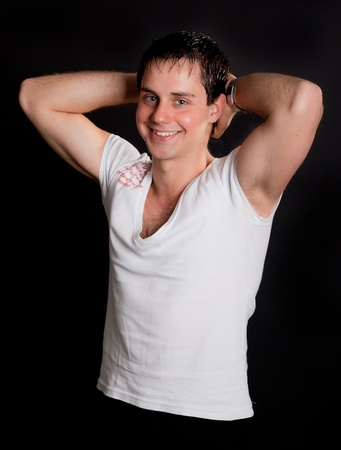 Young attractive happy man.black backgroundの写真素材