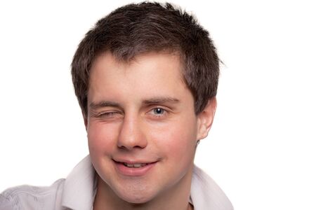 Cheerful young man winking and smilingの写真素材