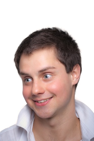 Closeup portrait of a handsome young guy smiling against white backgroundの写真素材