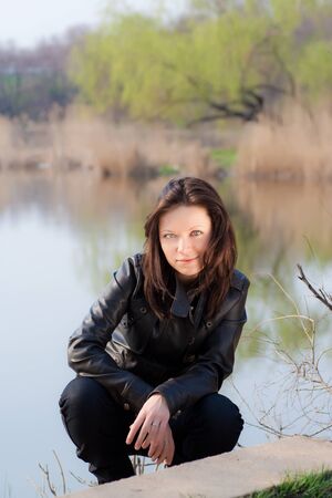 girl sitting on the bank rateの写真素材