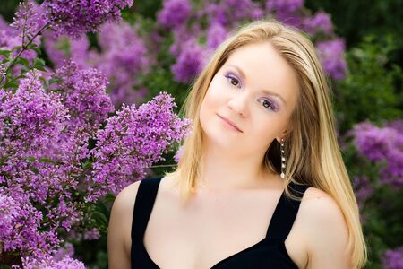 blonde girl near the lilacsの写真素材