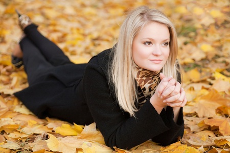 the girl lies on the yellow leavesの写真素材