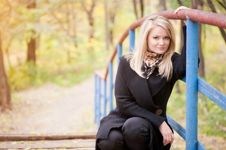 Autumn portrait of blonde girl on the Bridgeの写真素材