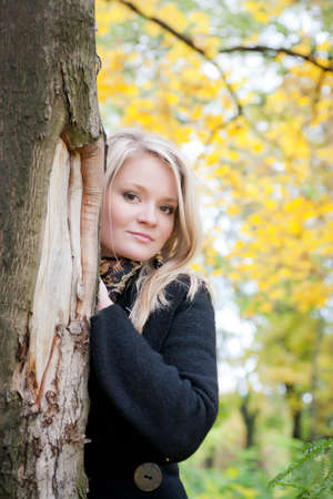 portrait of a girl standing near a treeの写真素材