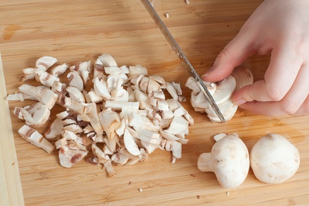 mushrooms on the cutting board with knifeの写真素材
