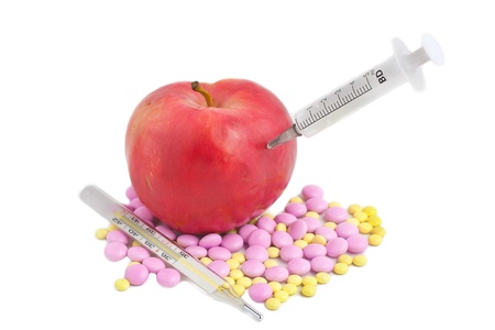 red apple pills and a thermometer isolated on whiteの写真素材