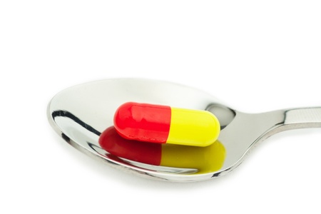 red and yellow tablet in spoon, macroの写真素材