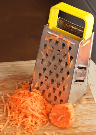 Crude grated carrots in a white cupの写真素材