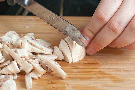 mushrooms on the cutting board with knifeの写真素材