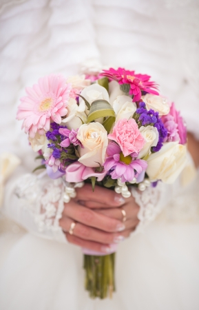 Beautiful wedding bouquet in hands of the brideの写真素材