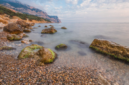 Sea, shore and stones. Seascape at sunset.の写真素材