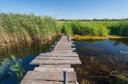 wooden bridge, the river, the old houseの写真素材