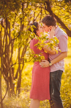 Portrait of young couple in flowering parkの写真素材