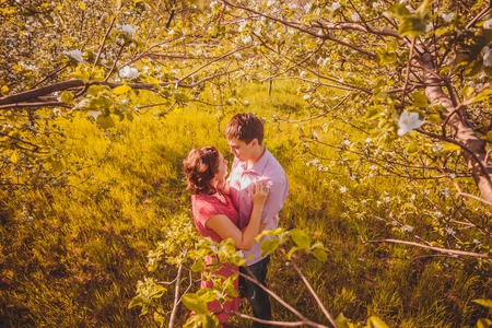 Portrait of young couple in flowering parkの写真素材