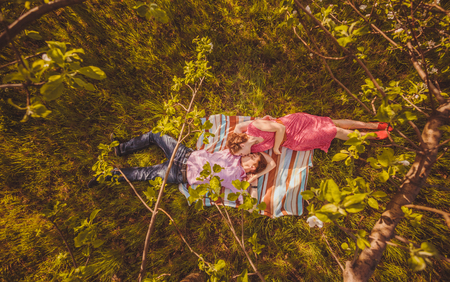 Portrait of young couple in flowering parkの写真素材