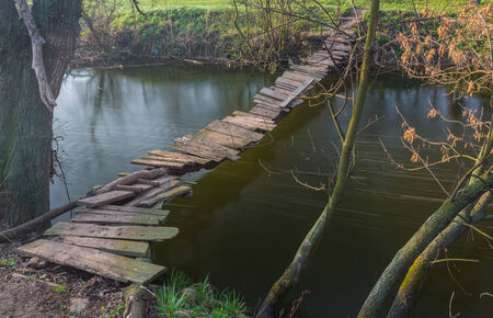 landscape with a wooden bridge over the riverの写真素材