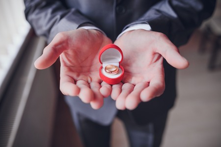 Engagement ring or present in the hands of a man in suitの写真素材