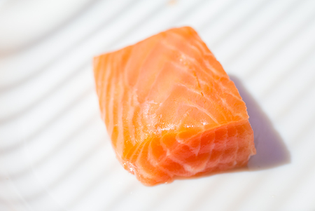 Three pieces of salmon on cutting boardの写真素材
