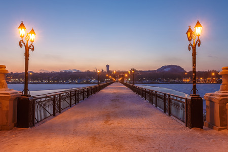 Bridge city landscape in snowy winter nightの写真素材