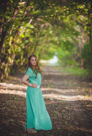Candid skipping carefree adorable woman in fieldの写真素材