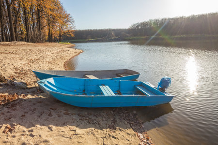 Two boats on the lake, pond. Yellow leaves of the trees.の写真素材
