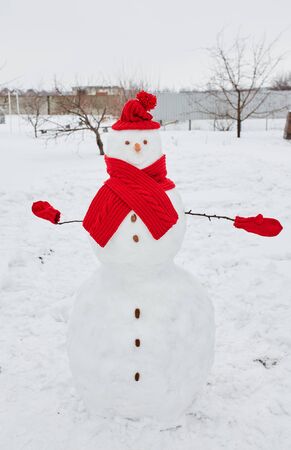 Real snowman outdoors in winter white scenery.の写真素材