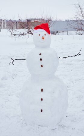 Real snowman outdoors in winter white scenery.の写真素材