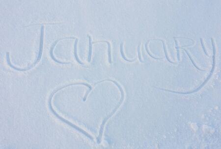 The word January written with broken wooden sticks on snow backgroundの写真素材