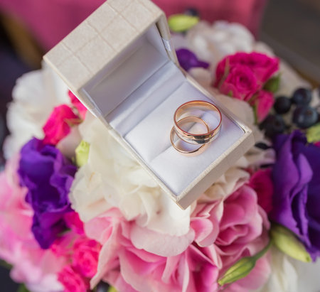 Two wedding rings in a jewelry box on white