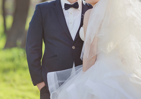 Elegant bride and groom posing together outdoors on a wedding dayの写真素材