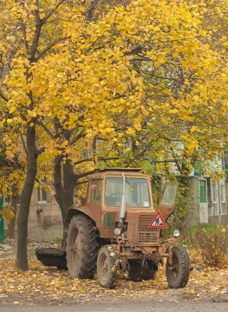 Red antique tractor in rural setting with autumn colorsの写真素材