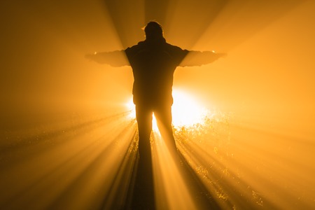 man with a torch at night in fogの写真素材
