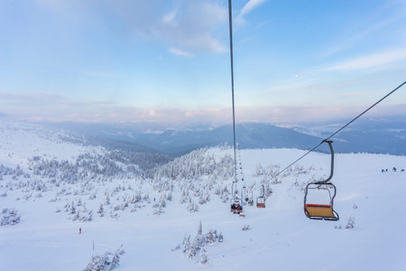Winter mountains panorama with ski slopes and ski liftsの写真素材