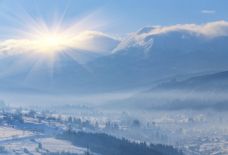Winter fairytale, heavy snowfall covered the trees and houses in the mountain village.の写真素材