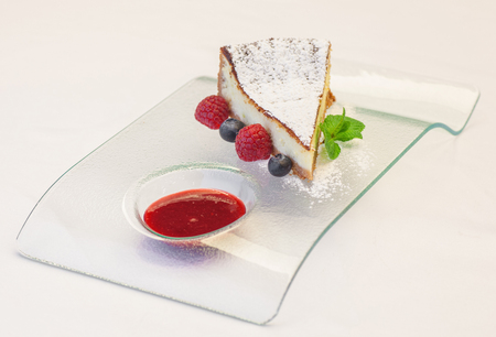 Cheesecake with fresh berries and mint on plate closeupの写真素材