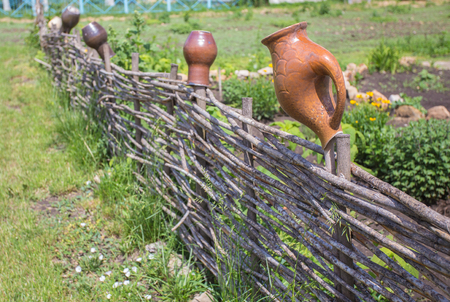 clay jug on wooden fence, take it in Ukraineの写真素材