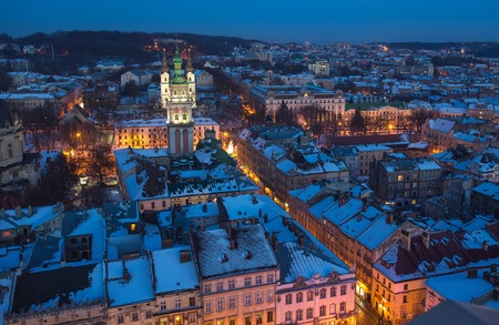 Winter view on the downtown in Lviv, Ukraine. Old buildings. Roofs covered by snowの写真素材