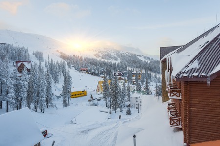 Winter resort with slopes for skiing and snowboarding with houses and liftsの写真素材