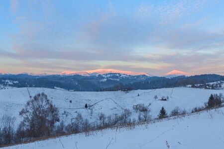 Old farm in the Carpathian mountains. Sunny winter morning. Retro style.の写真素材
