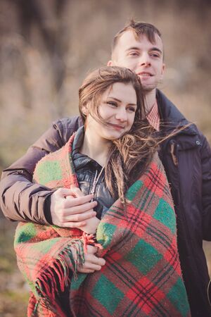 Young sensual couple sitting on the ground in park.の写真素材