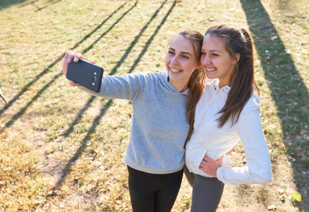 Beautiful girls taking a selfie with a smart phone.