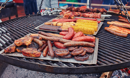 Close up image of pork sausages cooking on a flat grill.の写真素材
