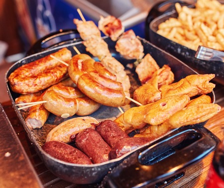 Close up image of pork sausages cooking on a flat grill.の写真素材